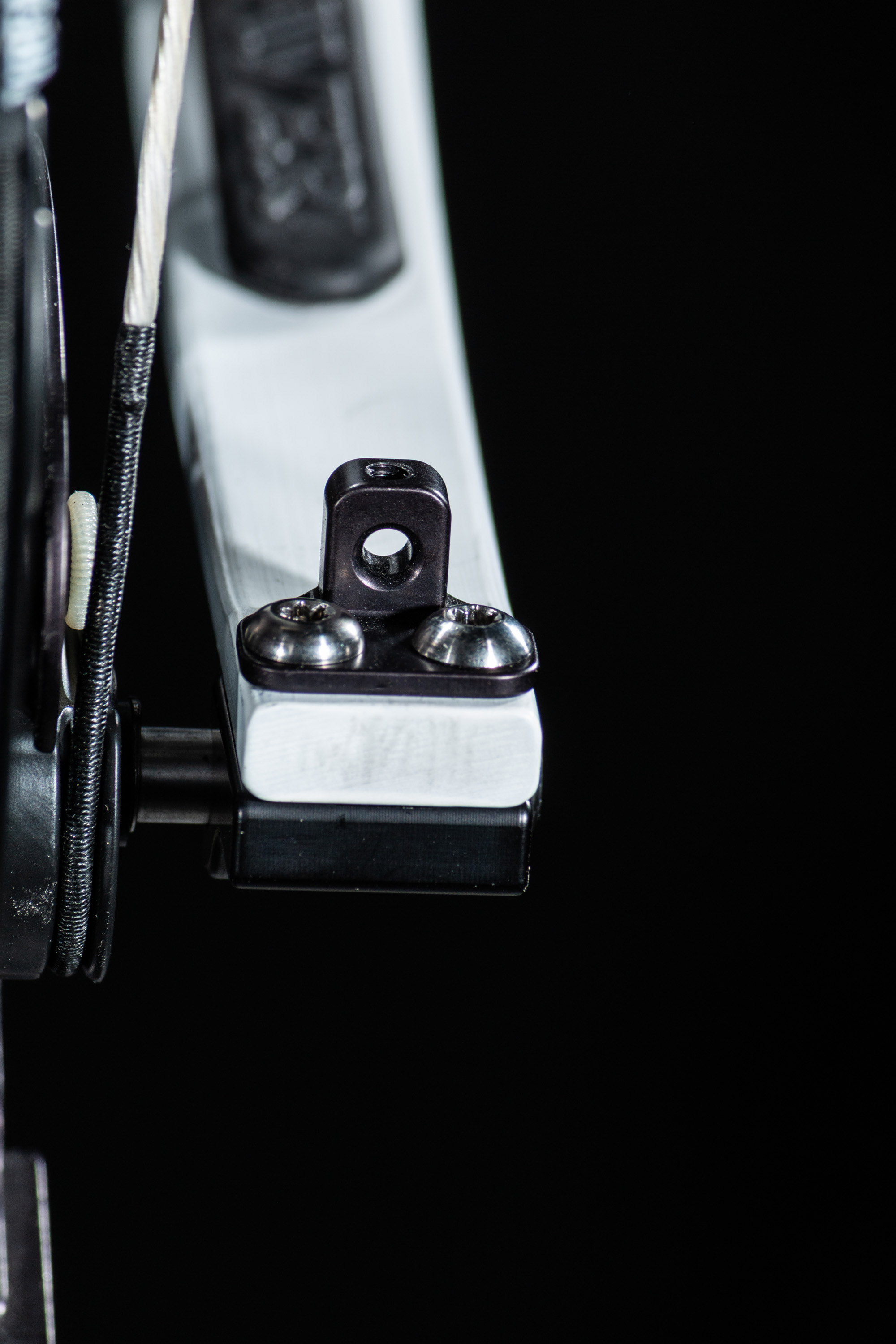 Limb-driven rest cord attachment — profile view